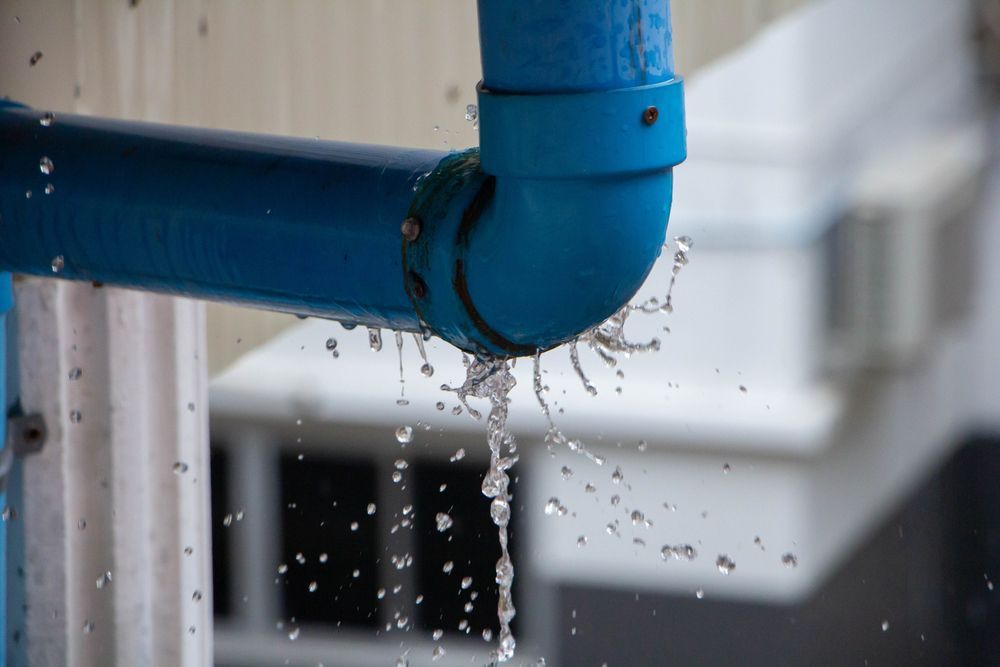 Blue Pipe Joint Leaking Water Droplets Outdoors — New Gen Plumbing and Gas in Banora Point, NSW