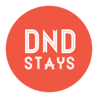 Red circle sign with white text reading “DND STAYS”