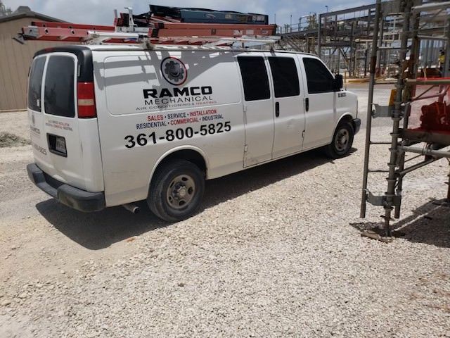 A bunch of vans are parked in front of a house.