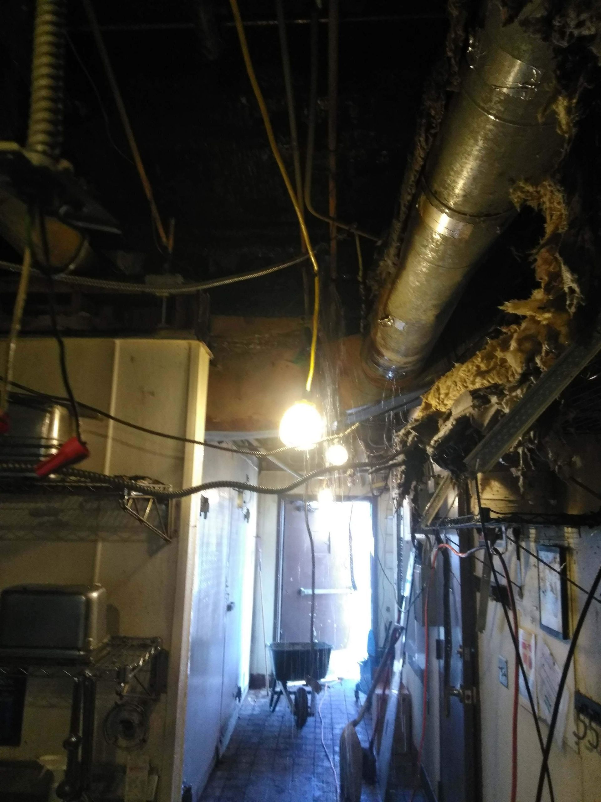 A dark hallway with a light hanging from the ceiling