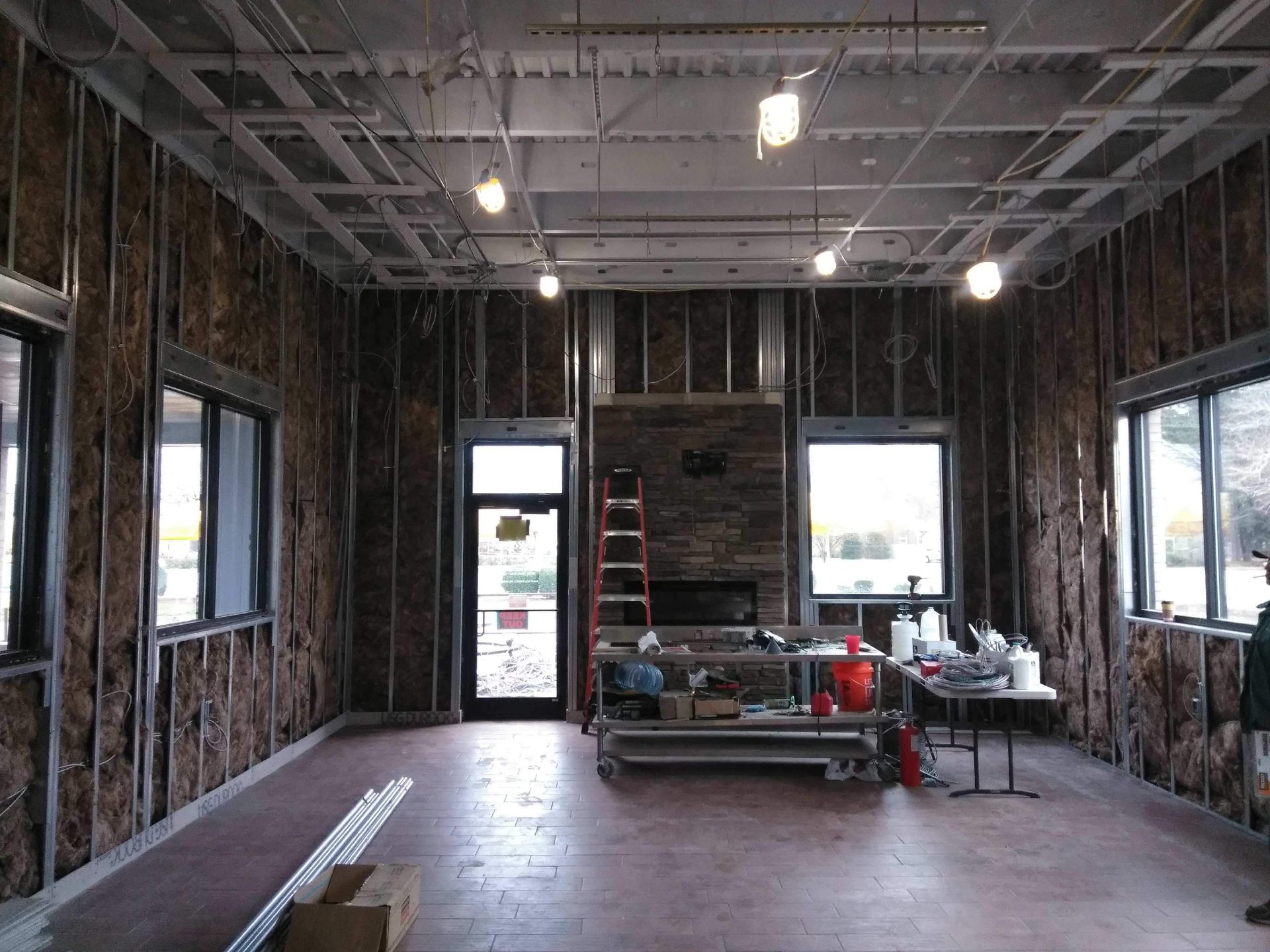 A large room with a lot of windows and a ladder