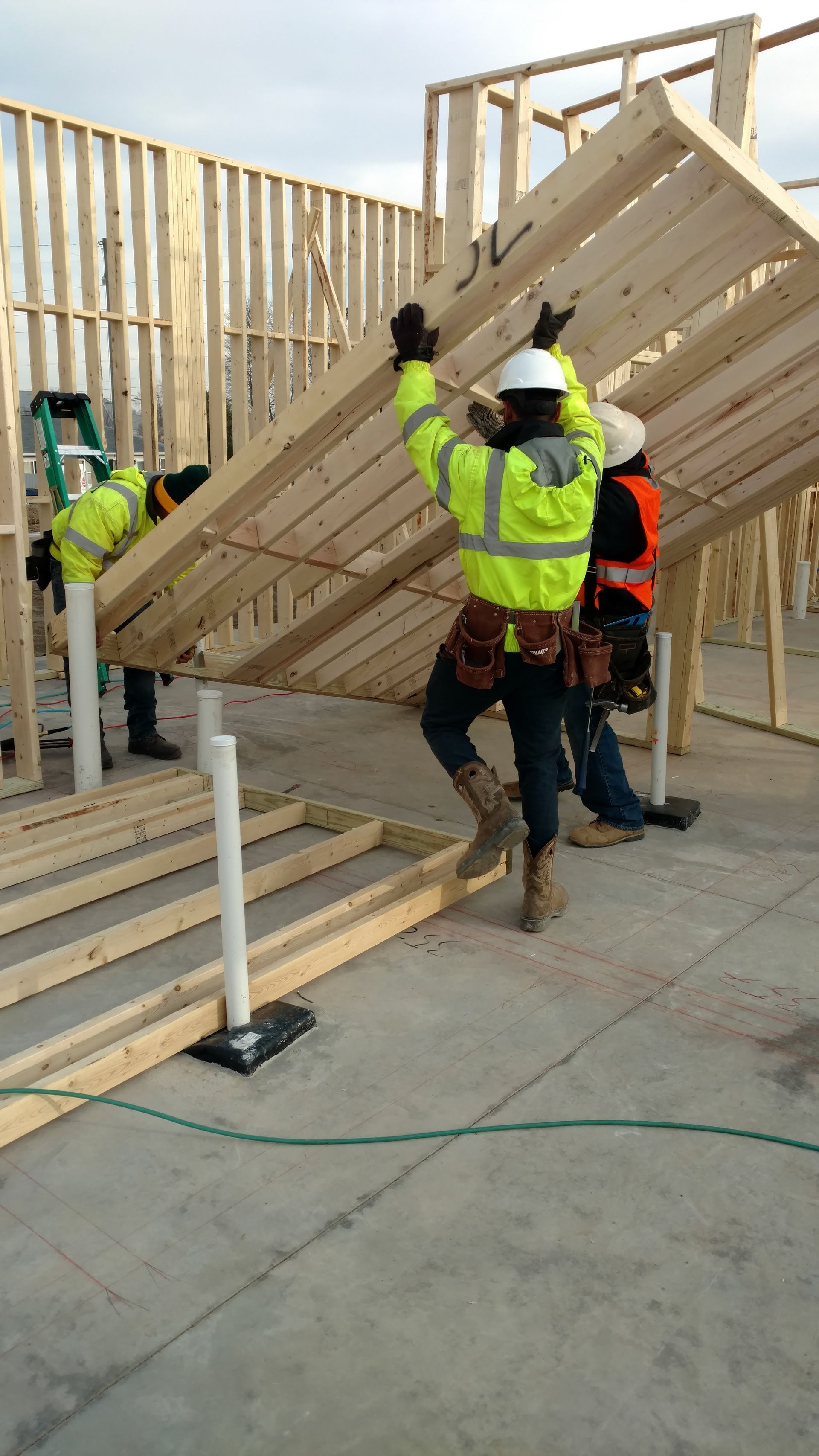 A group of construction workers are working on a wooden structure.