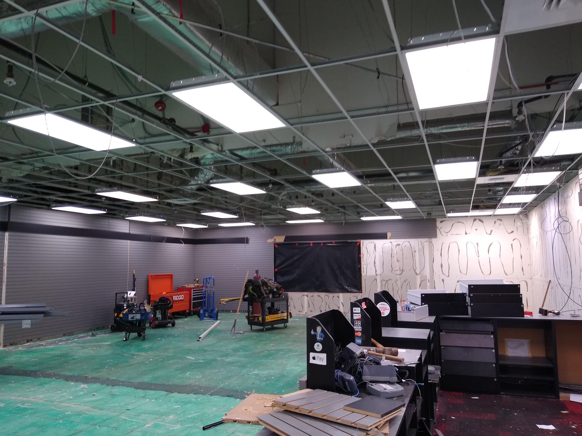 A large empty room with a lot of lights on the ceiling.