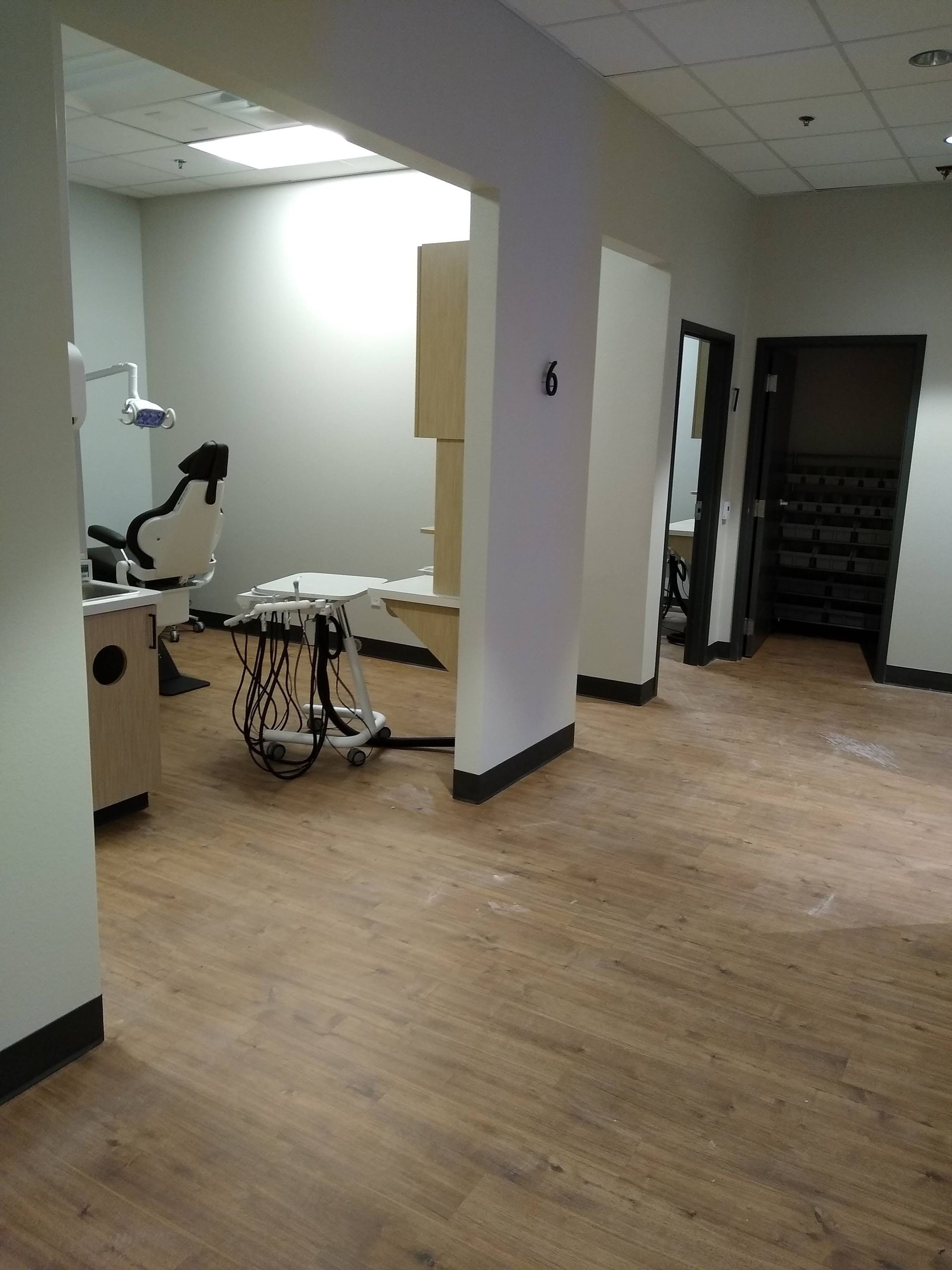 There is a dental chair in the middle of the room.