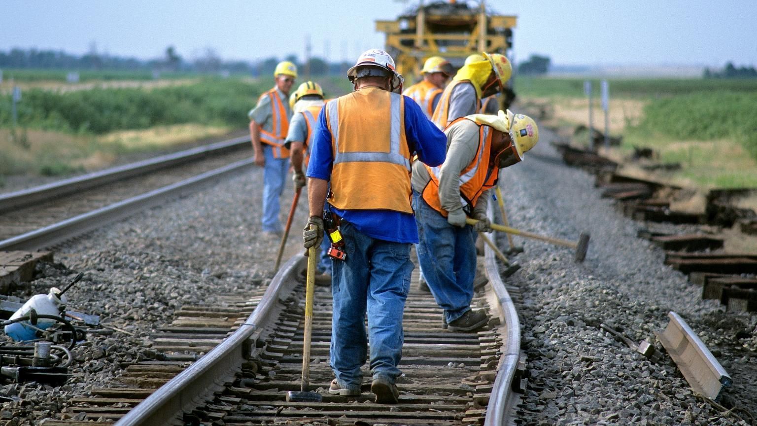 Railroad worker wearing hi-vis PPE and gloves