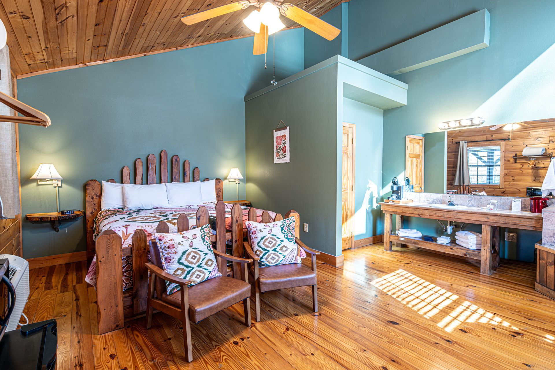 Bedroom with wooden furniture, teal walls, and a rustic style.