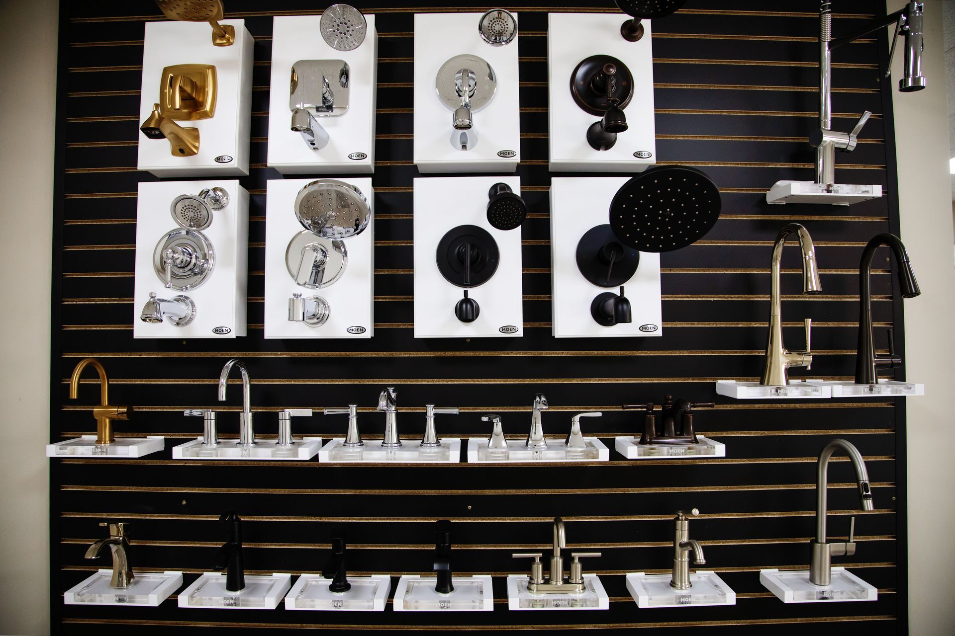 A kitchen sink with a faucet and a window in the background.