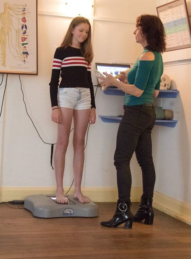 A Woman Examining A Girl — Trinity Family Chiropractic In Cairns, QLD