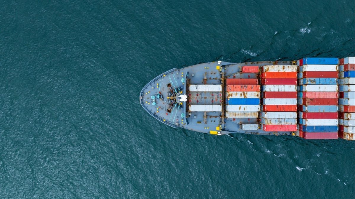 An aerial view of a large container ship floating on top of a body of water.