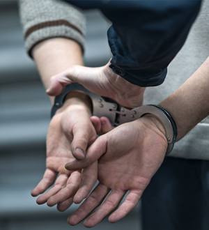 A man and a woman are handcuffed together