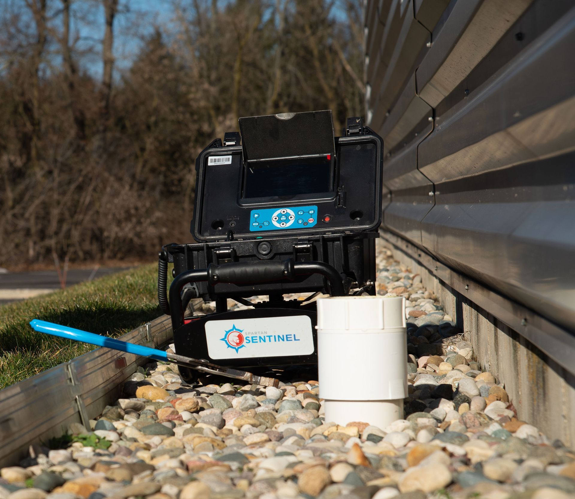 A machine that says central on it is sitting on a pile of rocks