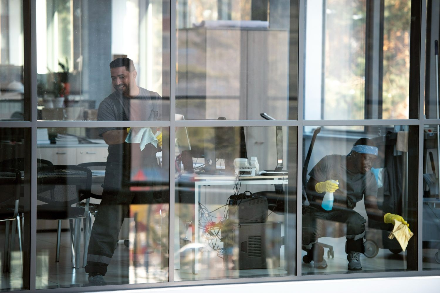 A man is cleaning the windows of an office building.
