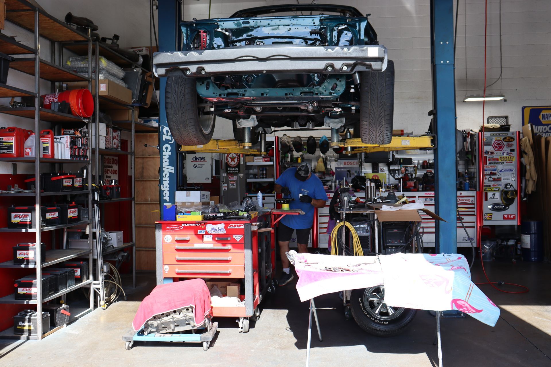 A Mechanic Is Working on a Car on a Lift in a Garage | Copperstate Auto And Fleet