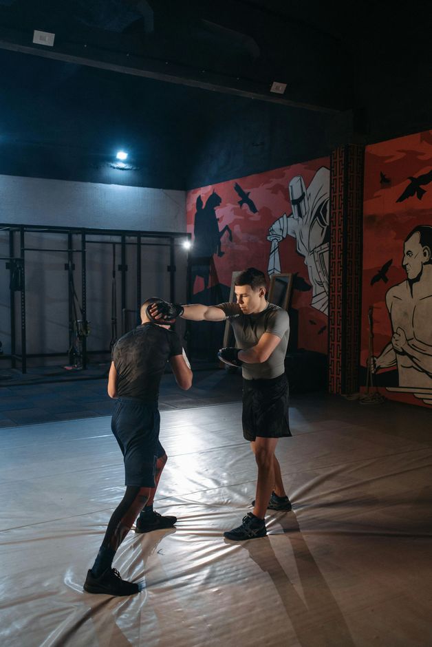 Two men are boxing in a gym.