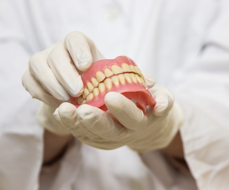 Dentures In The Hands Prepared For The Patient — Maitland Dental Care In Maitland NSW