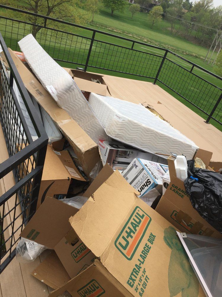 A pile of cardboard boxes with one that says u-haul on it