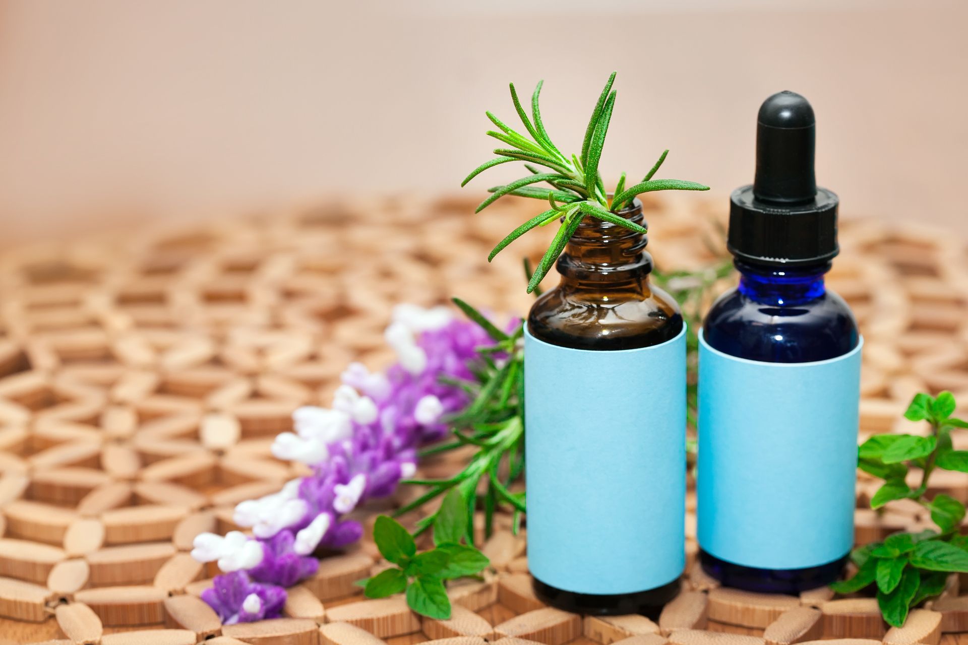Two bottles of essential oils are sitting on a wooden table.