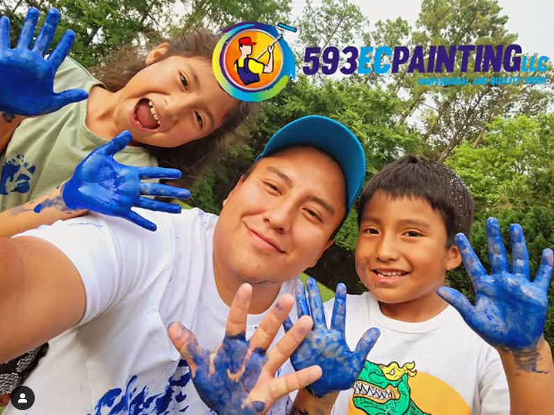 A man and two children are posing for a picture with their hands painted blue.