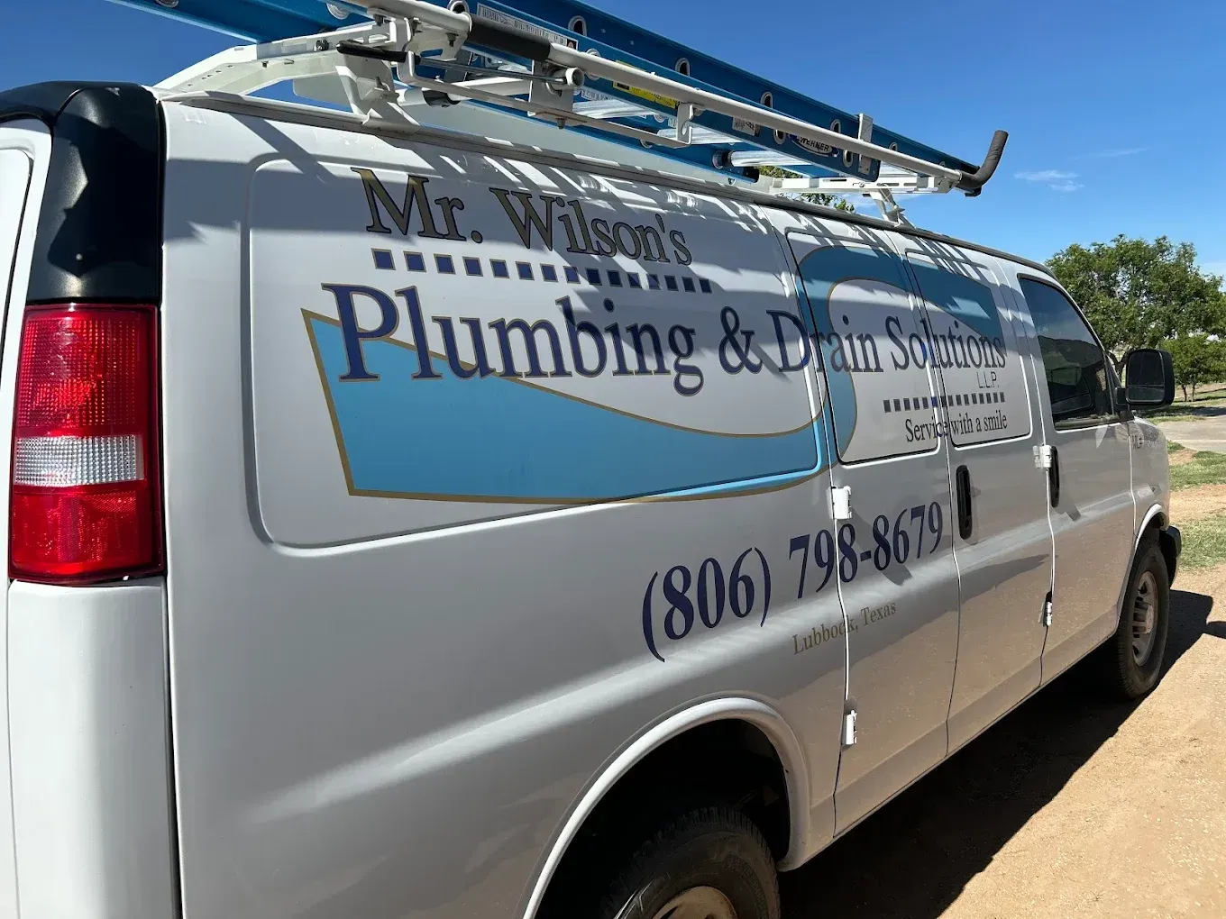 A white van for mr. wilson 's plumbing and drain solutions