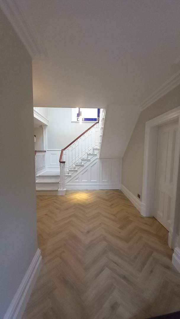 Staircase in period home – handrail restoration & crisp white panelling enhanced to highlight historic proportions