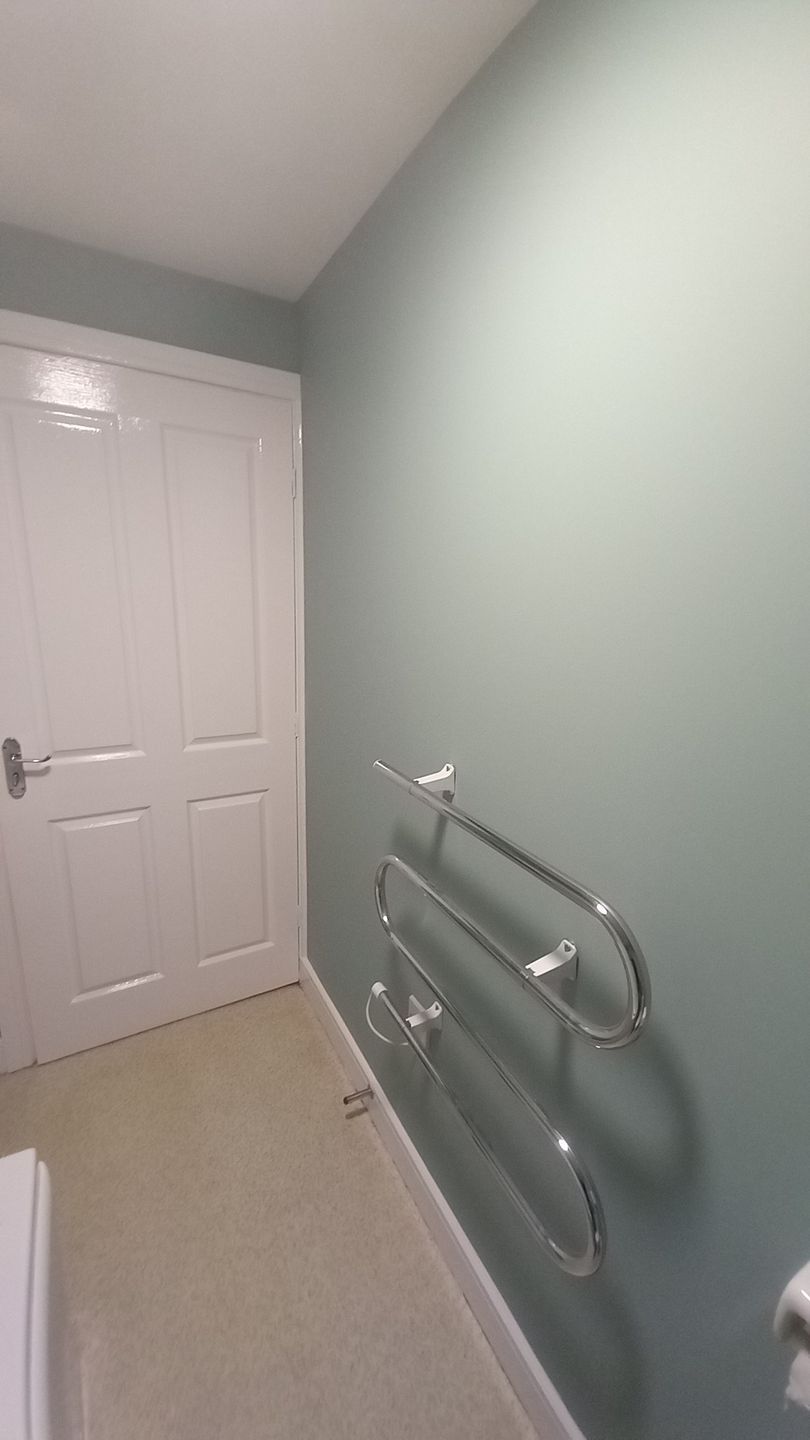 Social housing bathroom refresh – mint green walls coated with breathable, wipeable paint for hygiene and durability