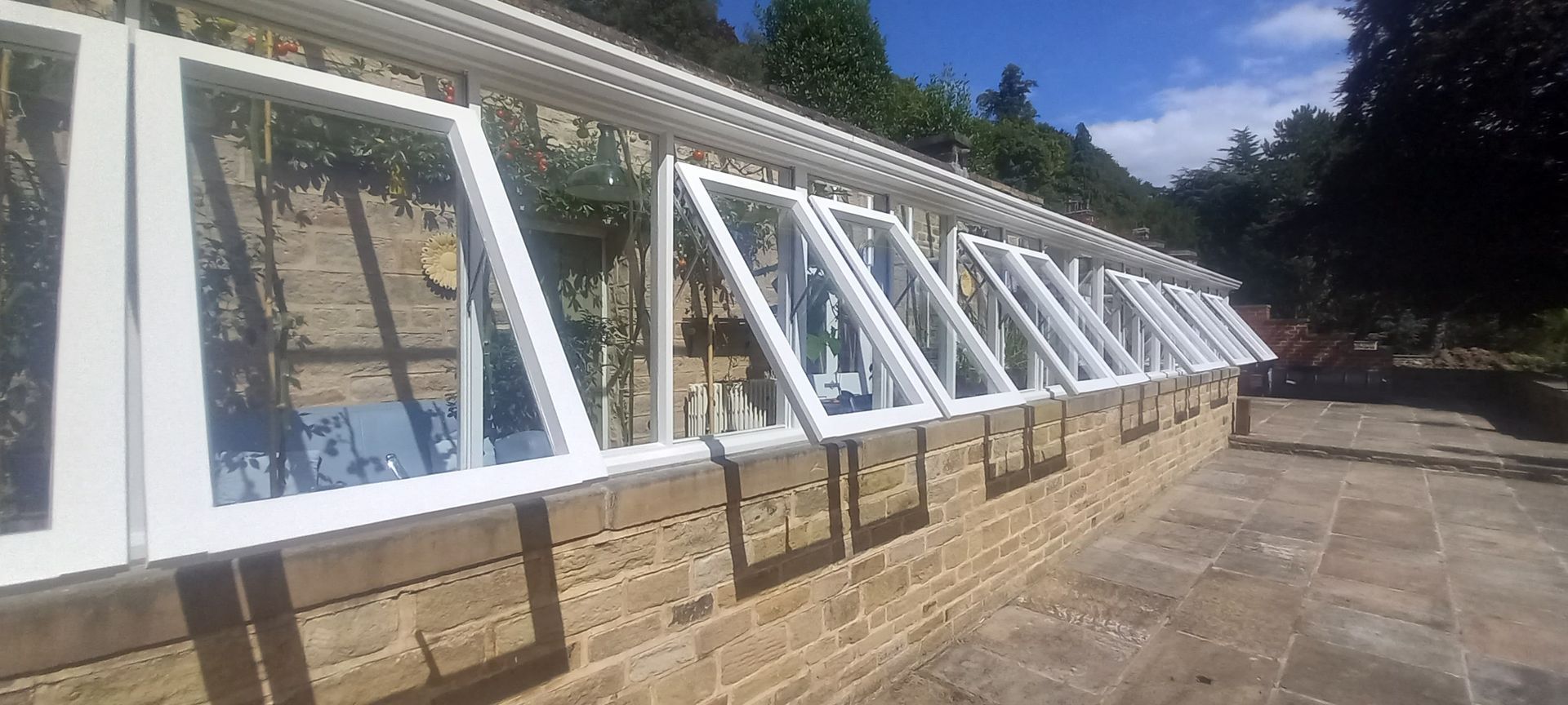 External maintenance on period conservatory–frames inspected, sealed and refinished to maintain integrity & elegance