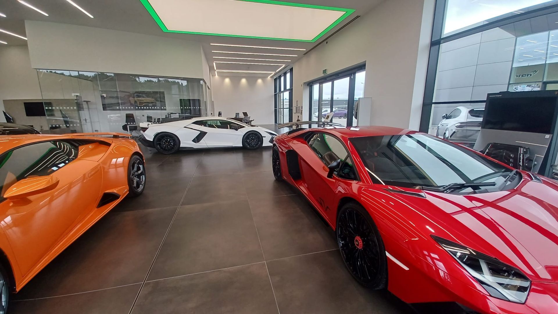 Luxury showroom refresh – timeless neutral palette and protective coatings creating an elegant backdrop for high-end vehicles