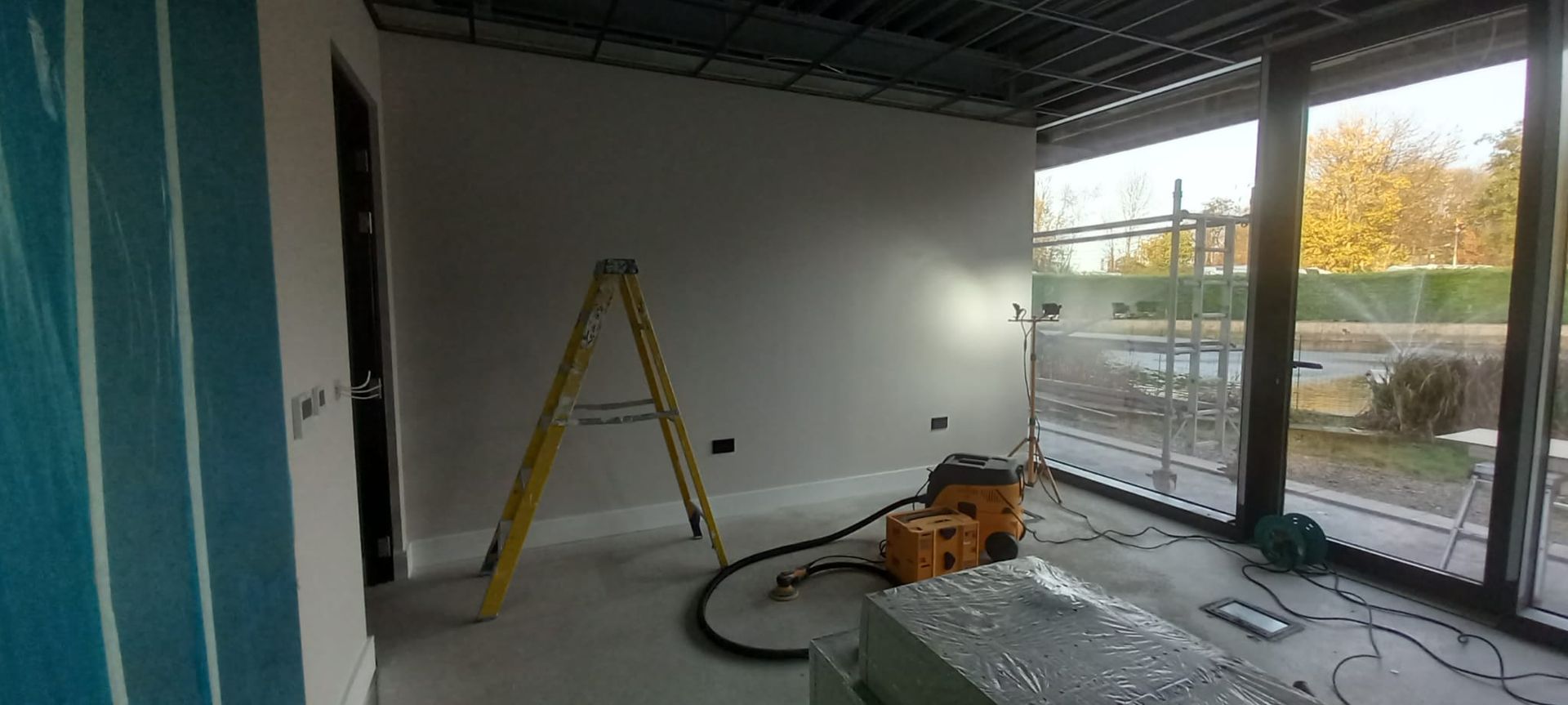 Careful substrate prep across contemporary workspace – dust-free sanding and protection preserving clean lines and fixtures