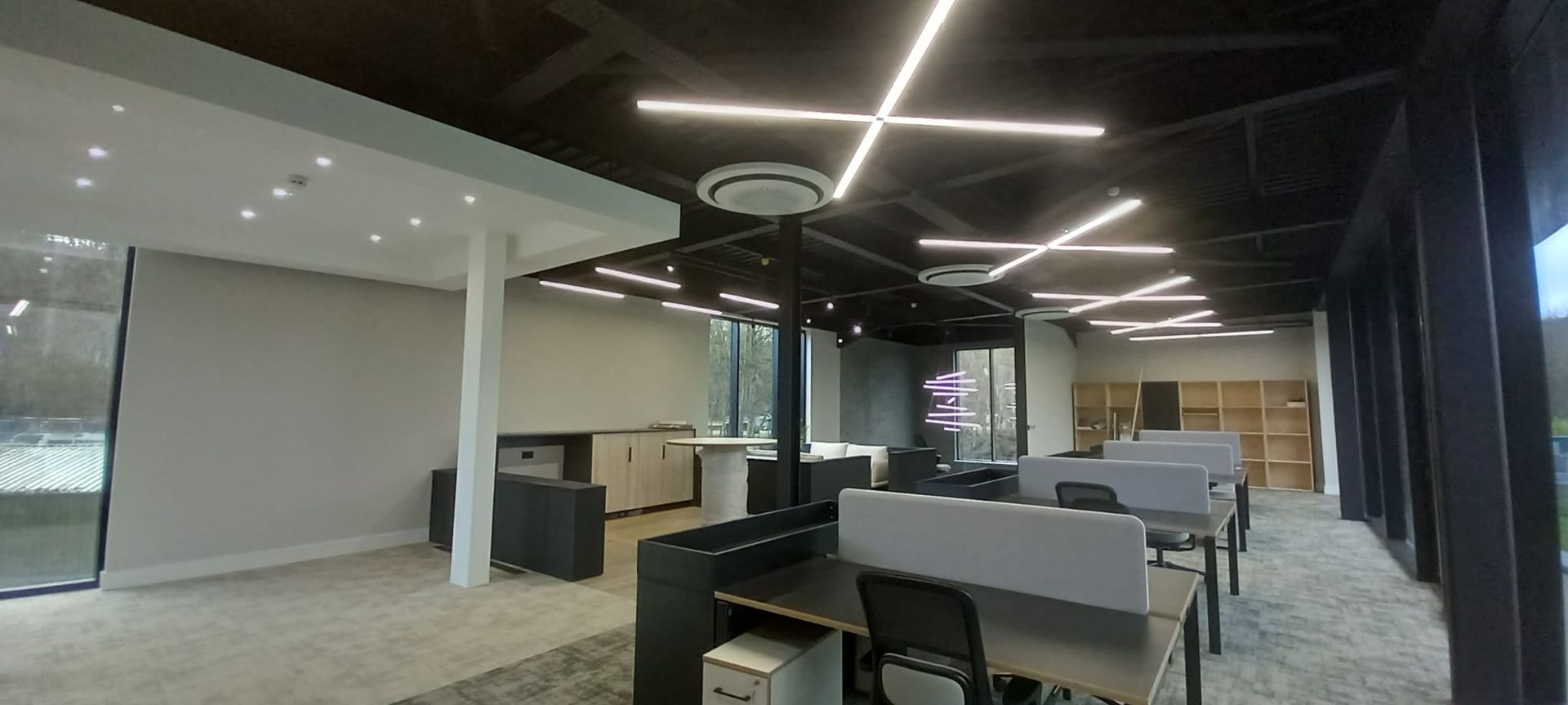 Commercial painting project – high-ceiling layout with exposed structure and recessed lighting coated with durable product