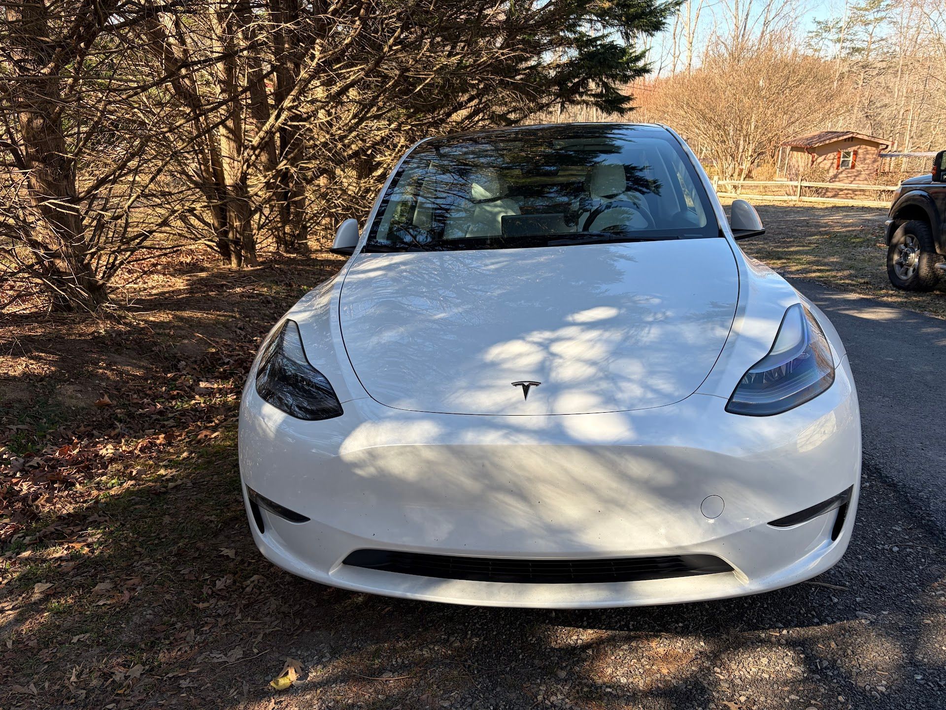 White Tesla Sedan Front View In Driveway | Pulse Automotive