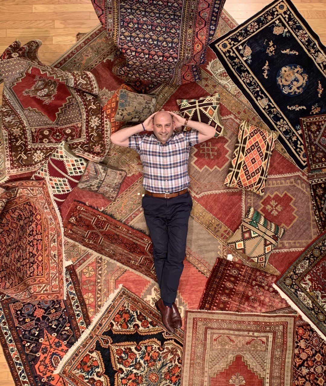 Man Lying on Carpets — Milwaukee, WI — Shabahang and Sons Persian Carpets