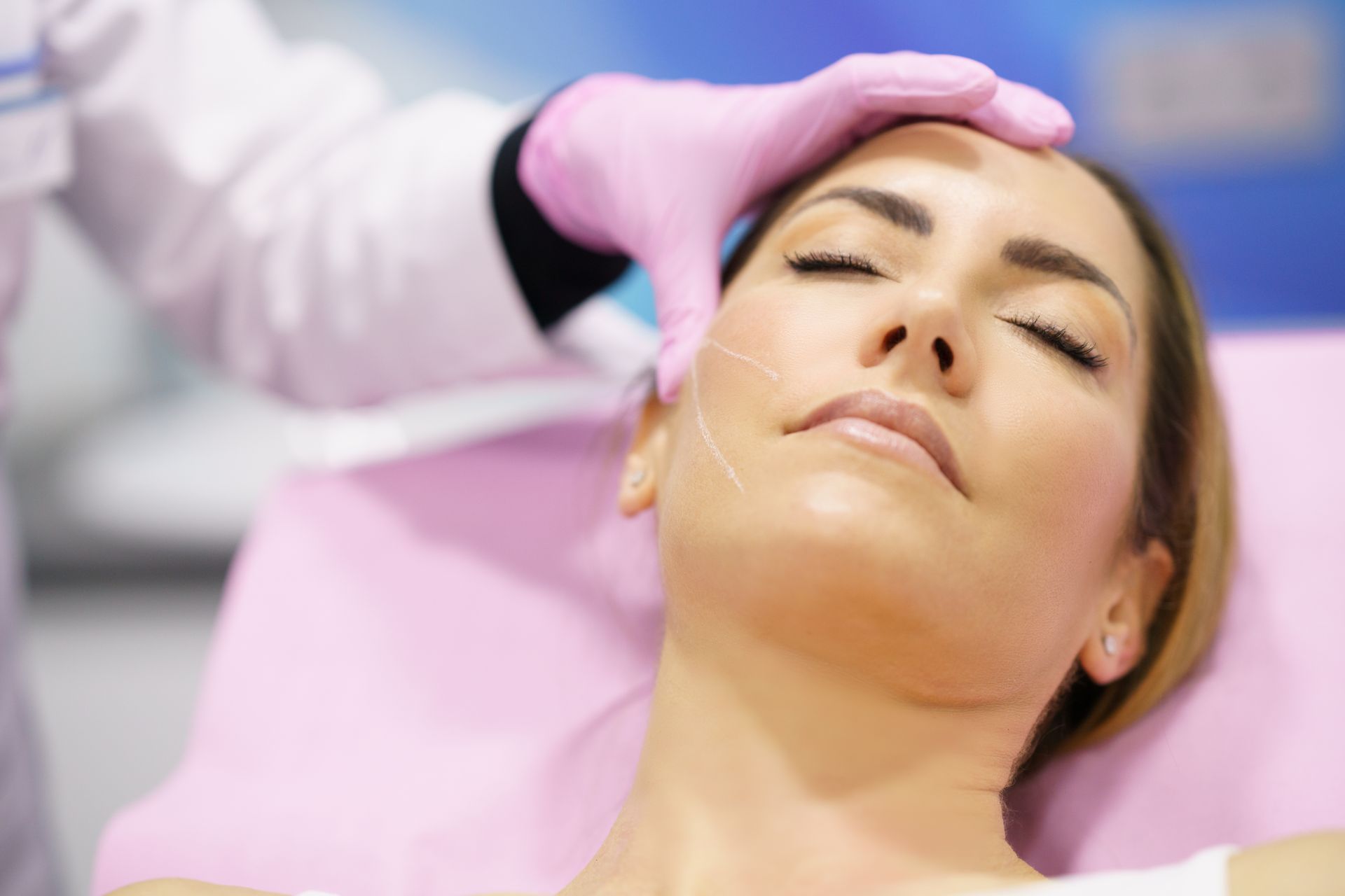 A woman is getting a botox injection in her face.