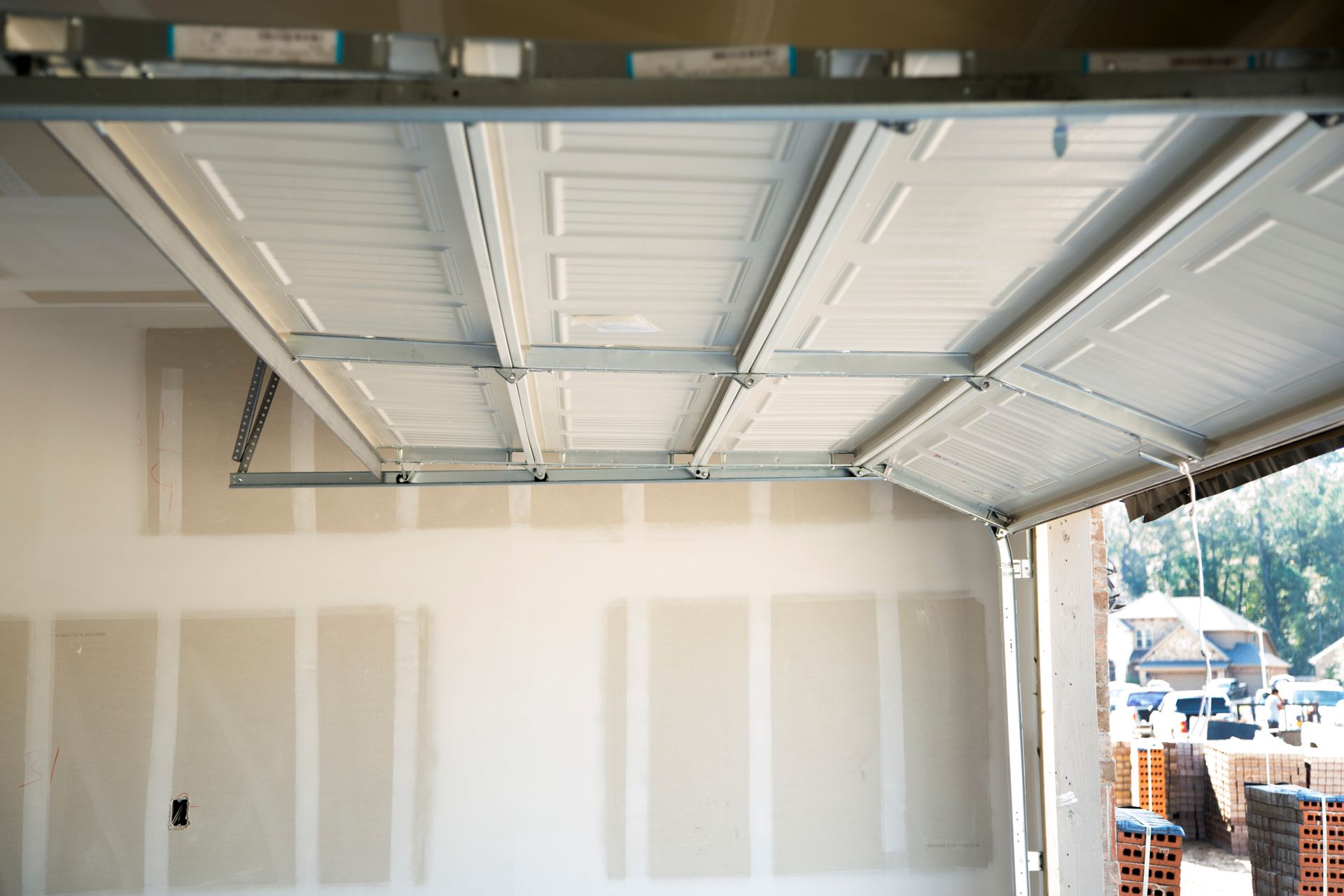 A garage door is open in a house under construction