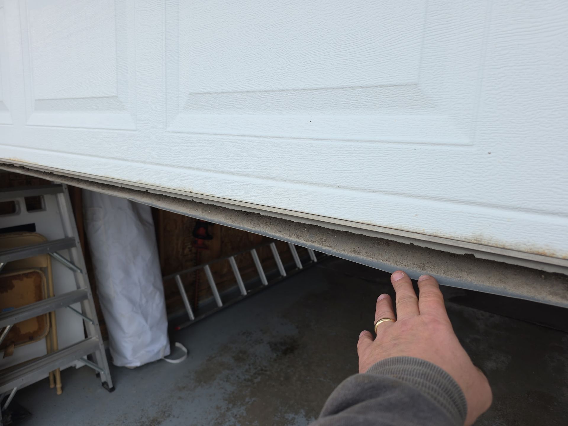A close up of a garage door lock on a garage door.