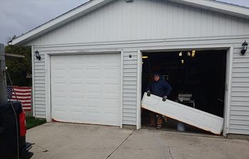 Worker Repairing Garage Door — Port Washington, WI — Jiffy Overhead Door, LLC