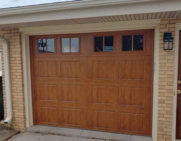 Wooden Garage Door With Four Windows — Port Washington, WI — Jiffy Overhead Door, LLC