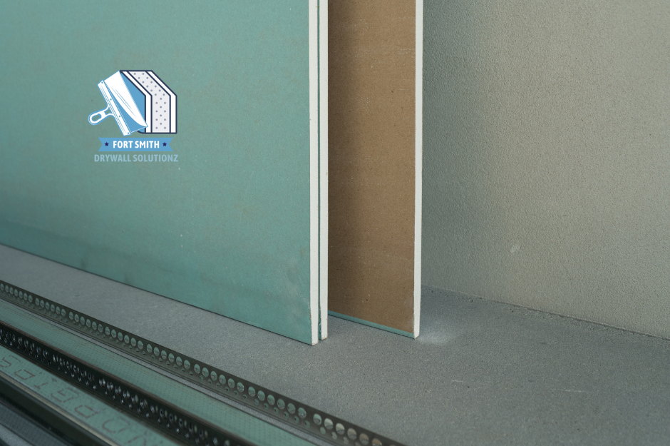 Close-up of drywall installation materials, showing clean sheetrock edges, green board, and corner bead setup.