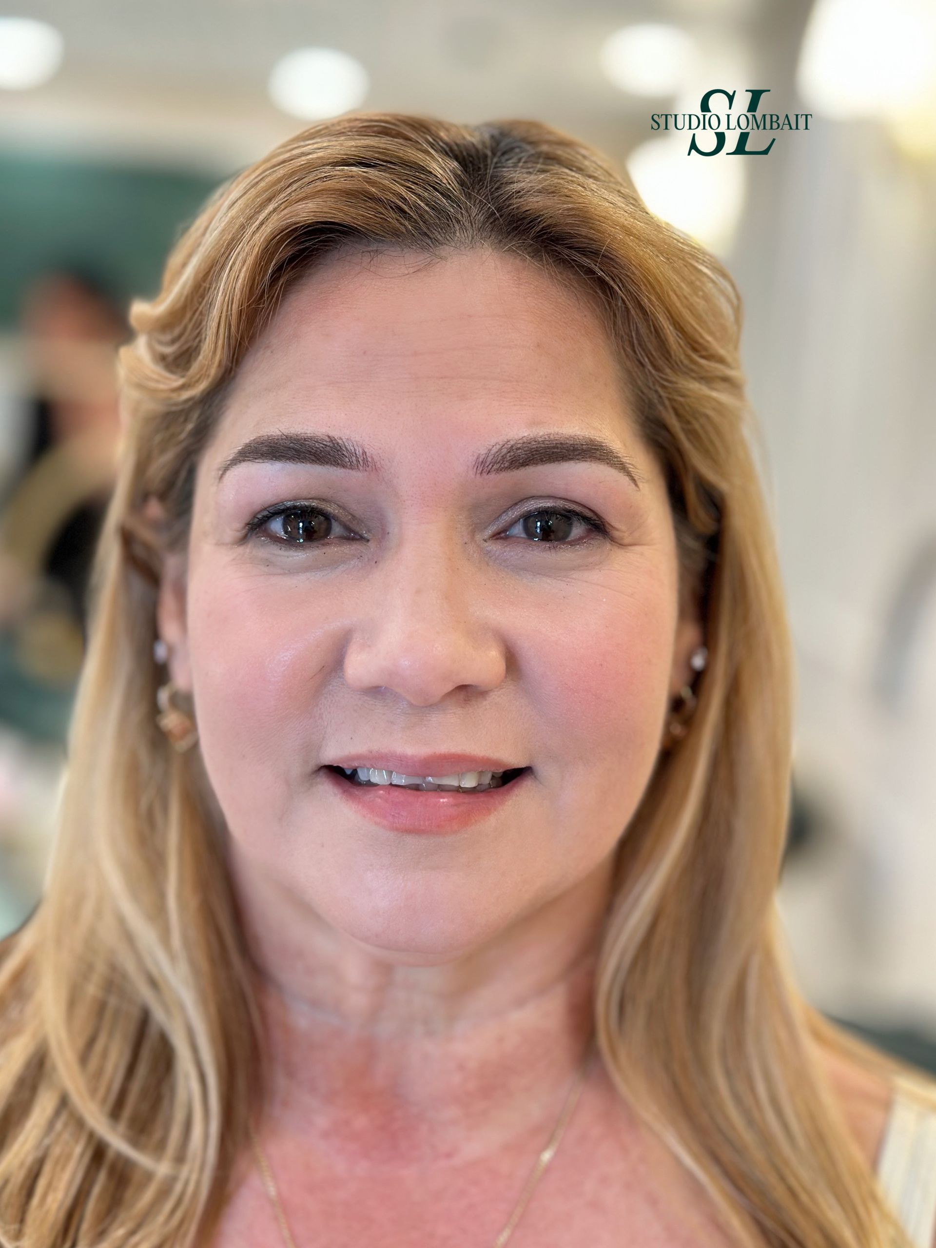 A close up of a woman 's face with long blonde hair.
