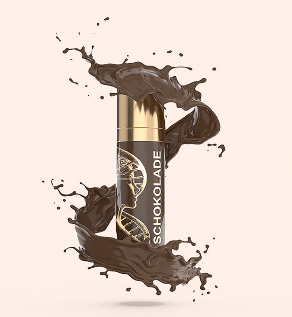 A bottle of chocolate liquid with a splash of chocolate coming out of it.