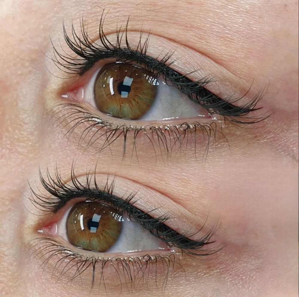 A close up of a woman 's eyes with long eyelashes and eyeliner.
