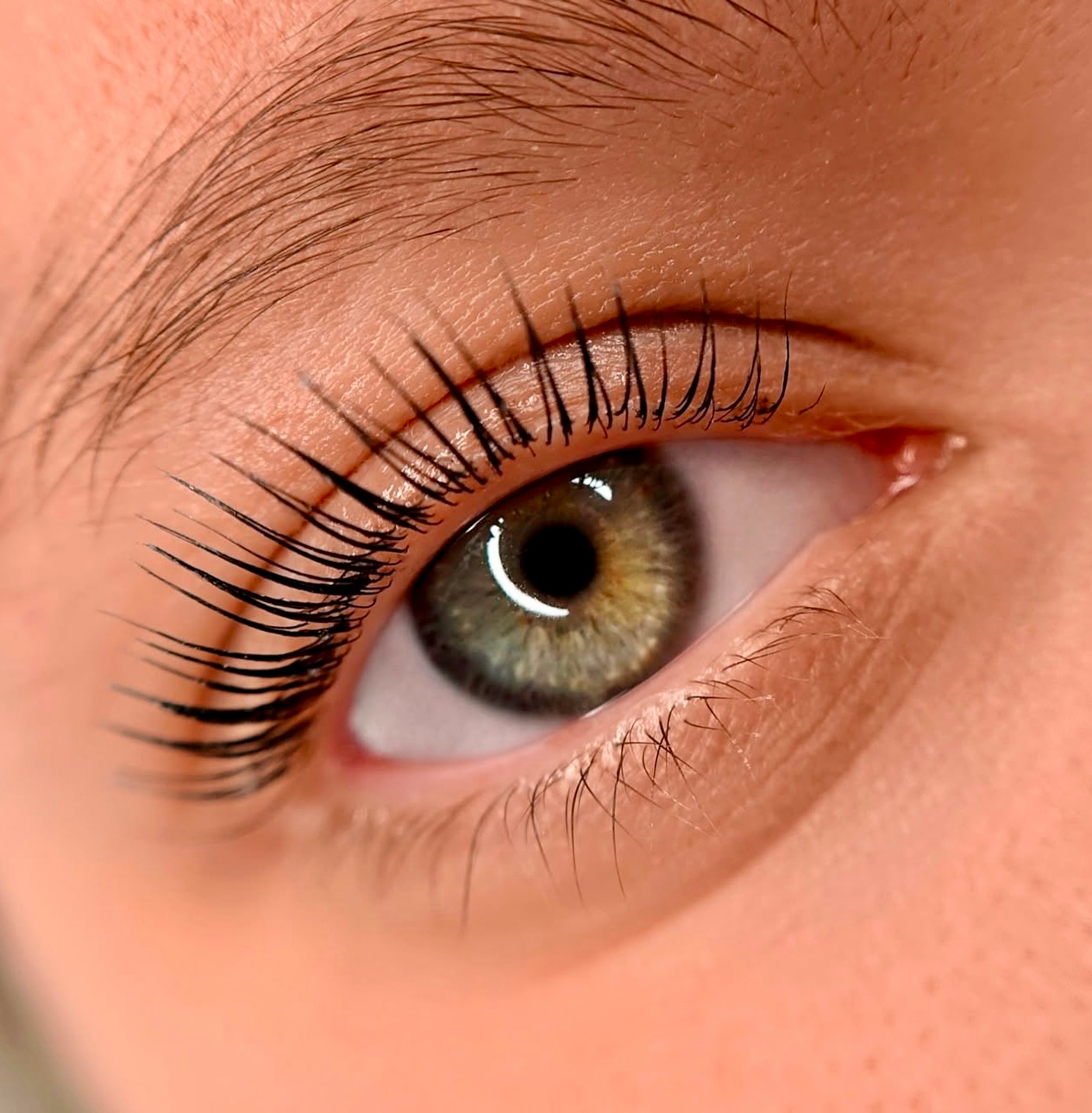 A close up of a woman 's eye with long eyelashes