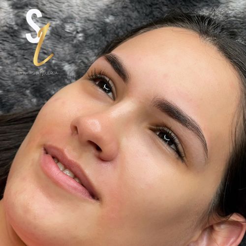 A close up of a woman 's face with a smile on her face.