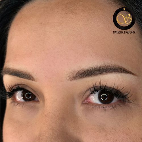 A close up of a woman 's eyes with long eyelashes.