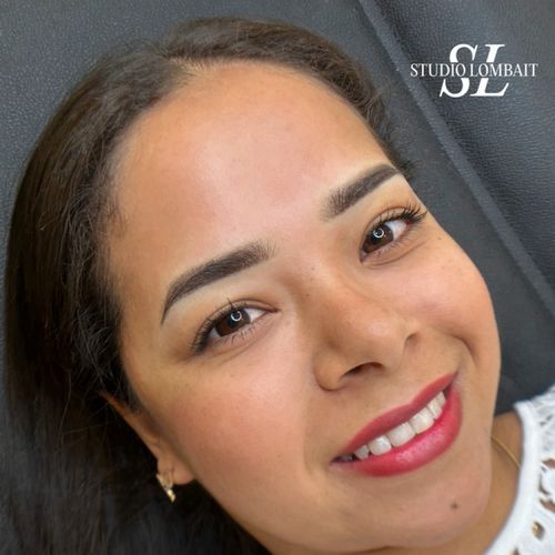 A close up of a woman 's face with a smile on her face.