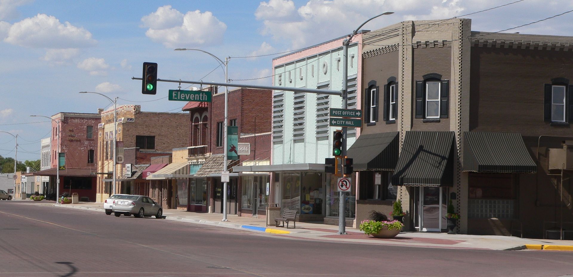 A small town street with a green traffic light