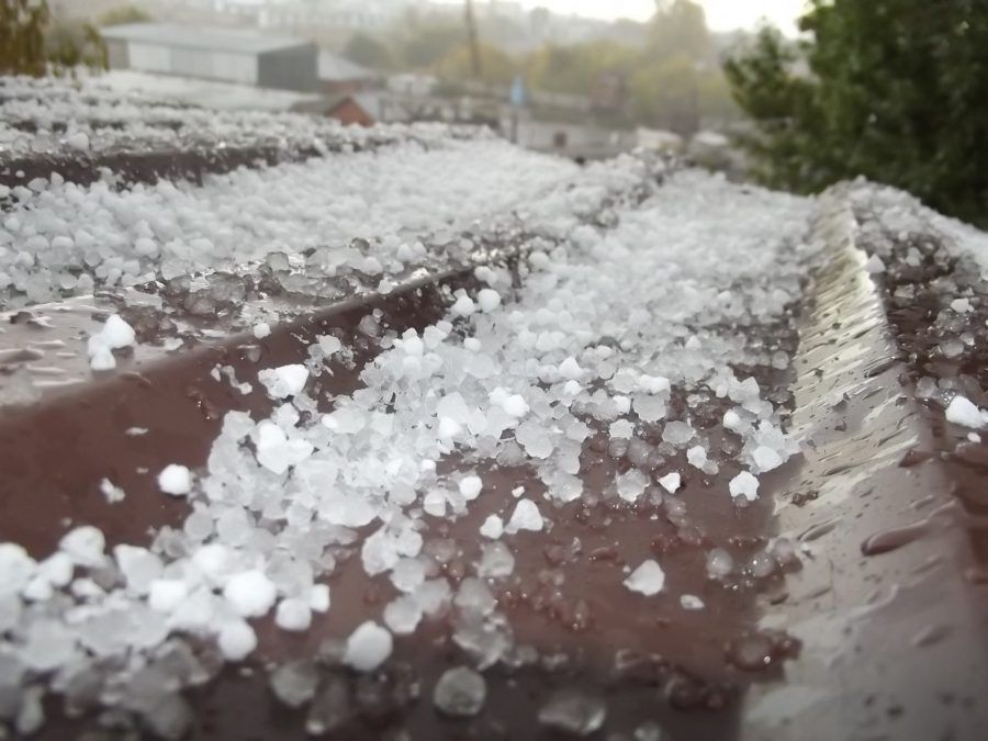 There is a lot of hail on the roof of a building.