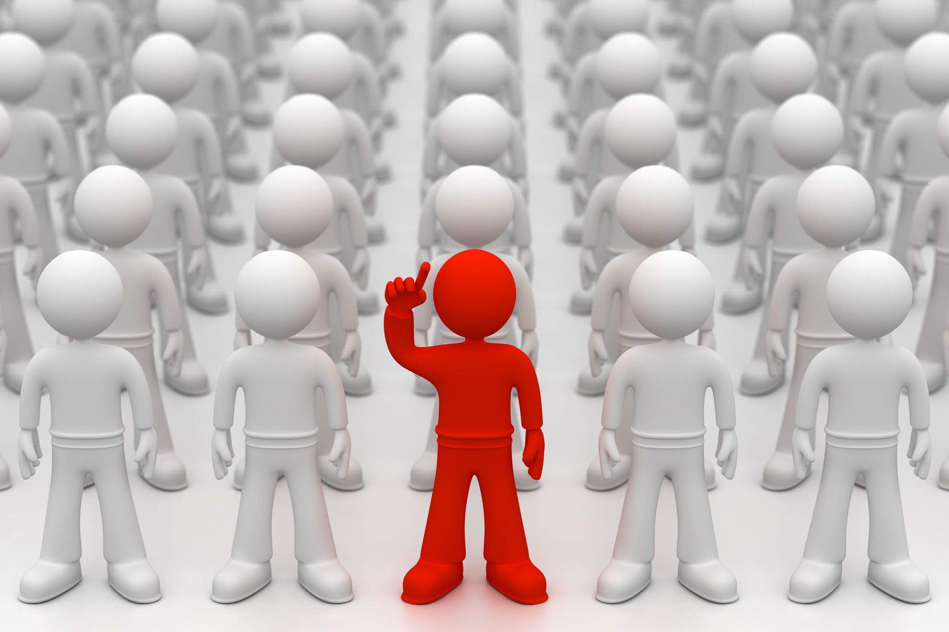 A red man is standing in front of a crowd of white people