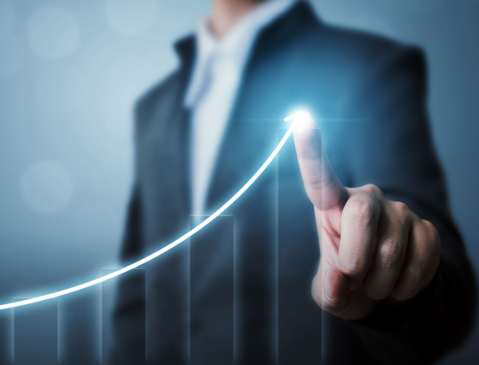 A woman is shaking hands with a man while sitting at a table.