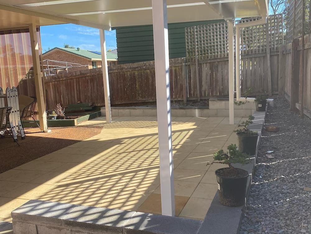A Backyard With A Covered Patio And A Fence — Millers Masonry In Port Macquarie, NSW