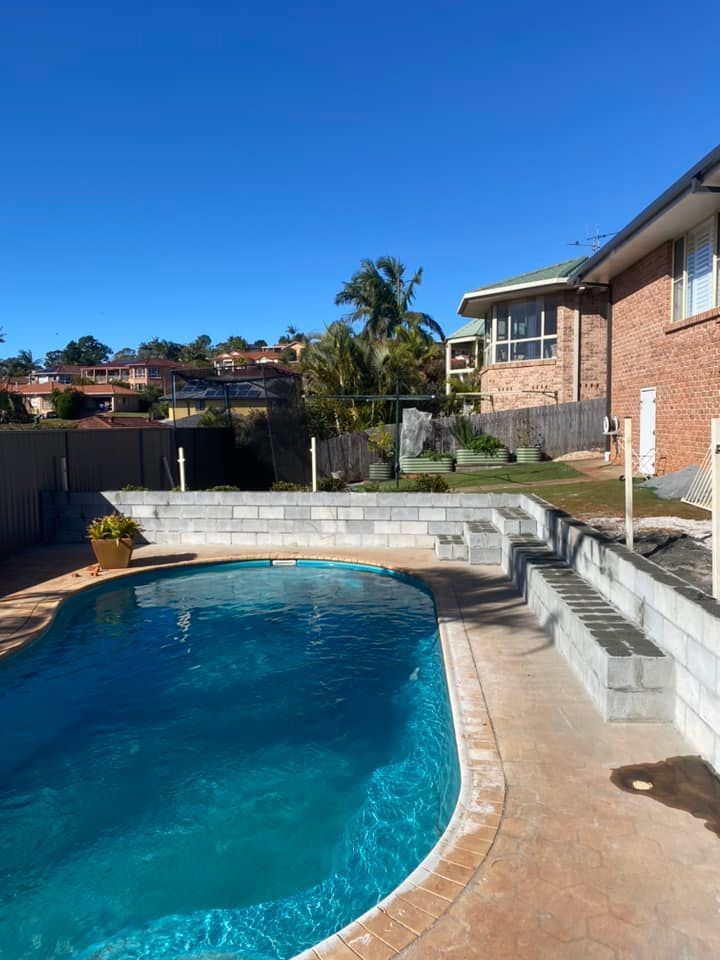 A Brick Wall around a Blue Pool — Millers Masonry In Port Macquarie, NSW